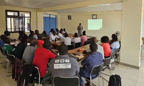 Kisii County ambulance team sitting in a classroom watching a presentation from Dr Kinane.